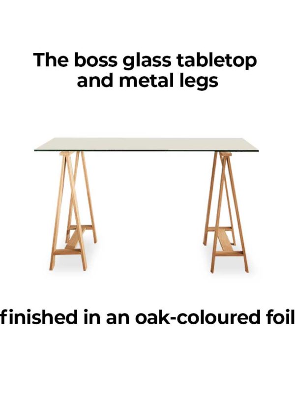 Waverley Trestle Desk, is a boss glass tabletop and metal legs finished in an oak-coloured foil.